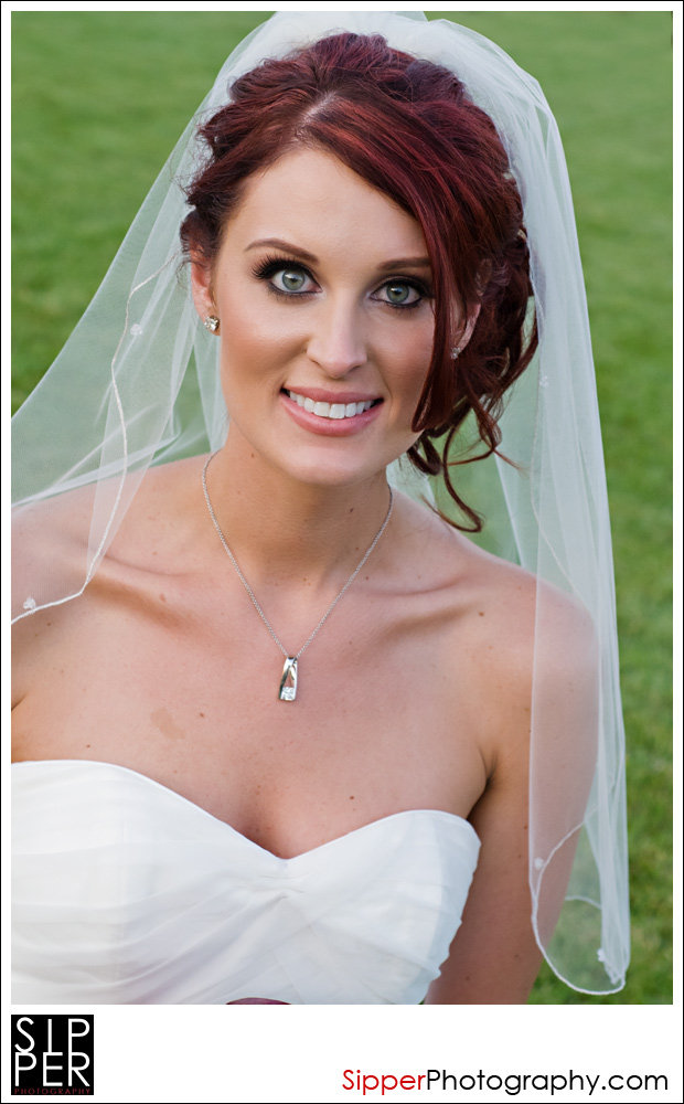 Bride smiling on the Great Lawn at Woodbury, Irvine, CA