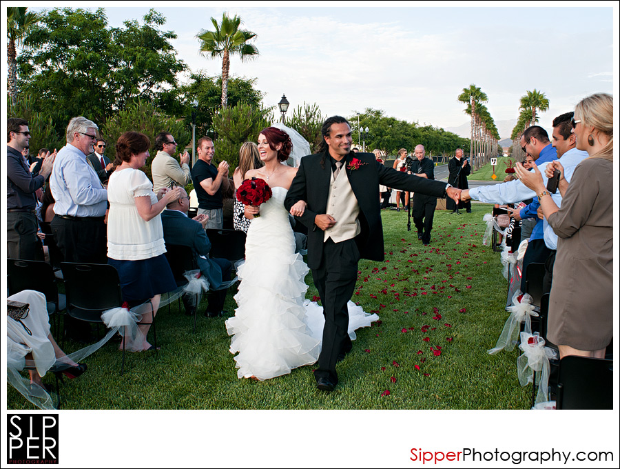 Groom fist-bumping a guest on the Great Lawn at Woodbury, Irvine CA