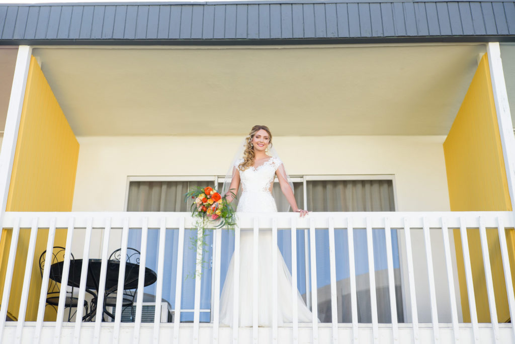 Bride on the Balcony at The Anaheim Hotel across the street from Disneyland. Anaheim Wedding and Event Venue